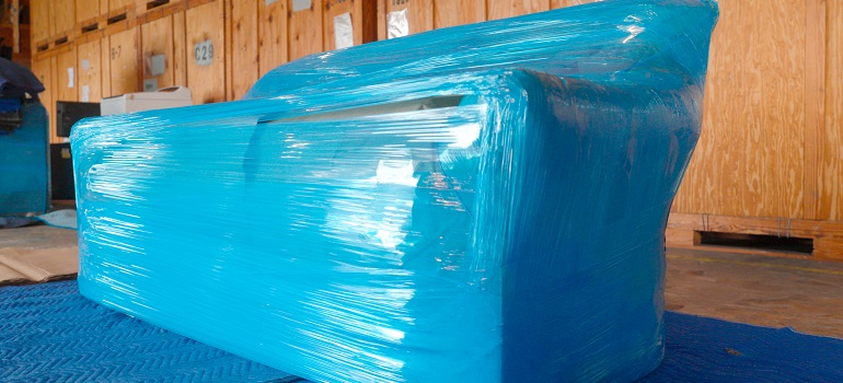 a sofa wrapped in a plastic cover