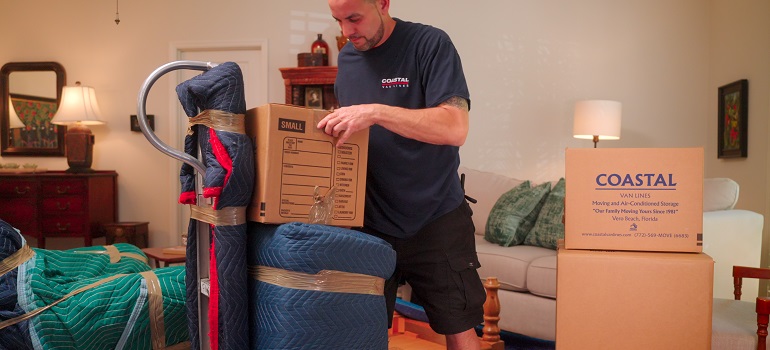 a mover carrying one of the things you should recycle after moving