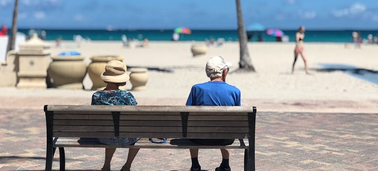 seniors sitting at a bench