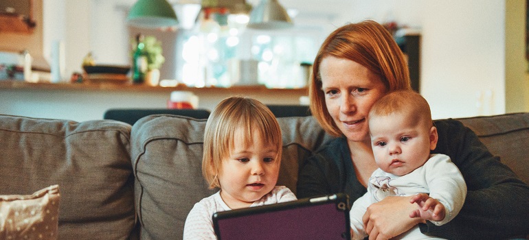 a mother exploring fun activities online after moving from Titusville to Melbourne with kids