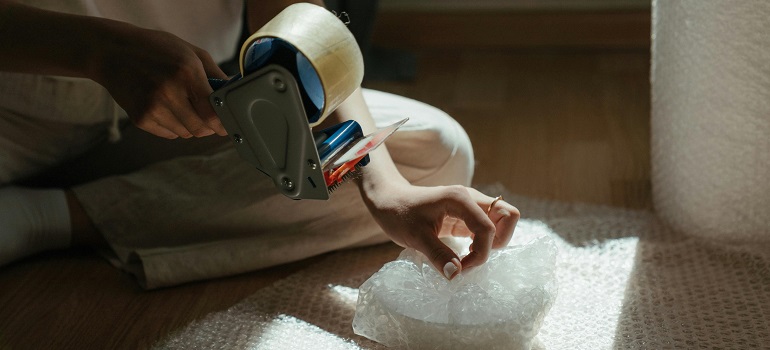 a girl packing breakables for a move