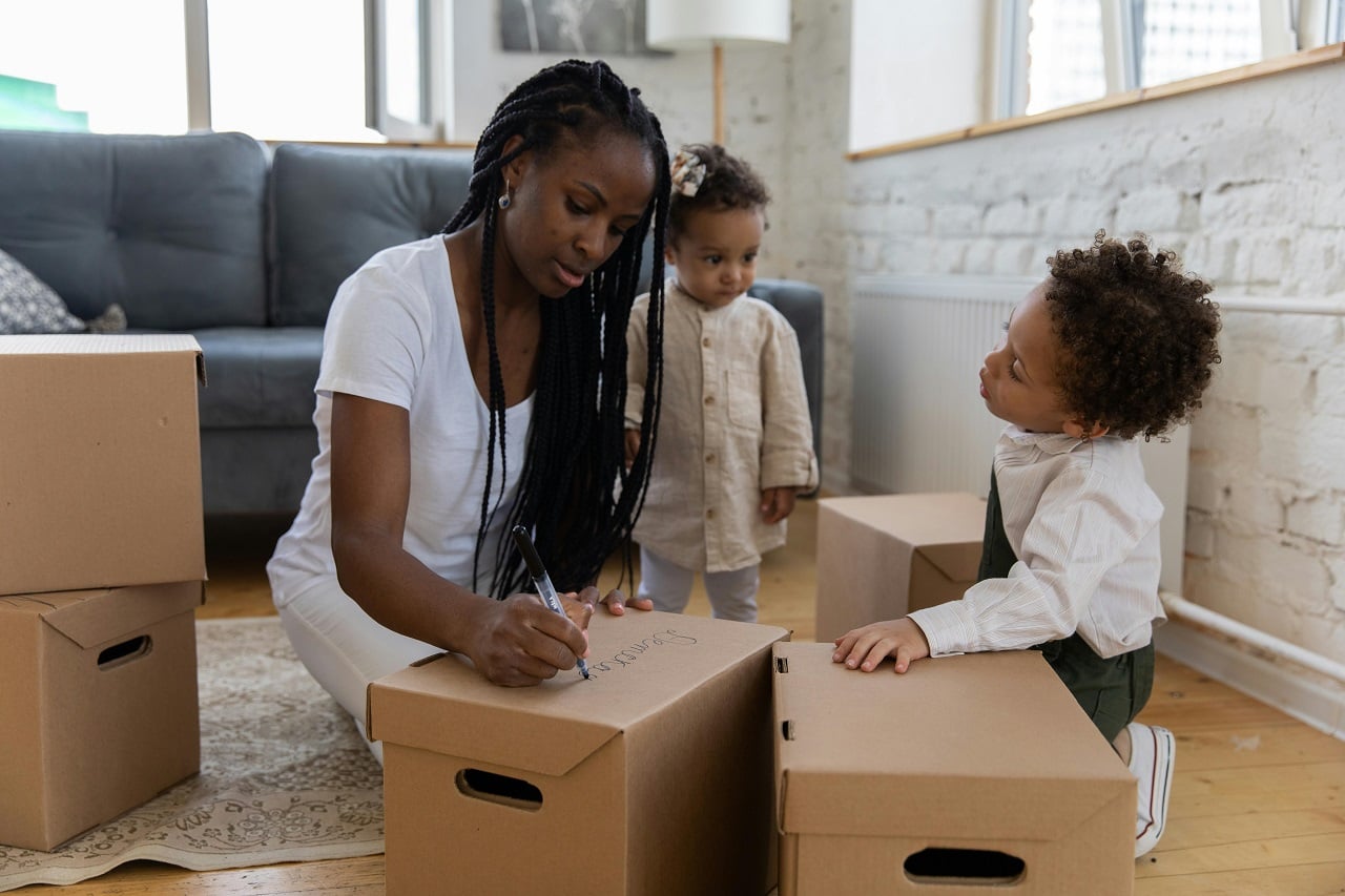 a family packing moving boxes