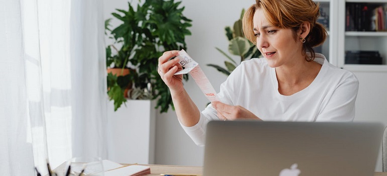 Woman reviewing moving checklist on laptop.