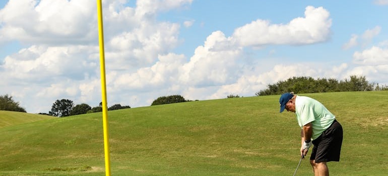 Man golfing on a sunny golf course