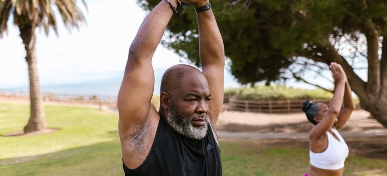 Senior stretching arms in a park in one of the top Enjoying outdoor activities at locations in St Lucie County for seniors
